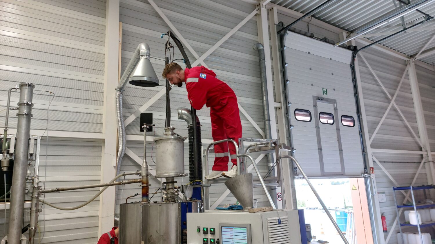 Man looking into machine. First testing phase of SoualiGas
