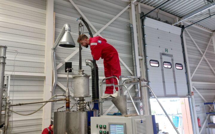 Man looking into machine. First testing phase of SoualiGas
